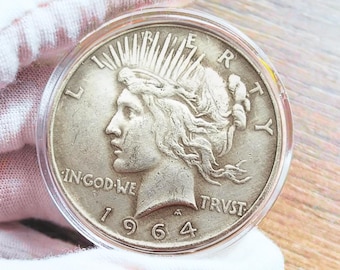 Moneda conmemorativa de plata Peace Dollar de 1964D, pieza rara para coleccionistas.