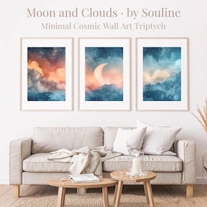 May include: Minimalist cosmic wall art triptych with three framed prints. Each print displays a watercolour depiction of a celestial scene with a moon, clouds, and stars. The colour palette includes shades of blue, orange, and white.