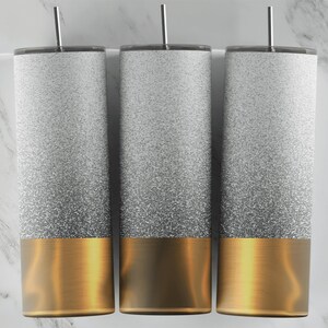 May include: Three stainless steel tumblers with a white glitter ombre design and a gold base.