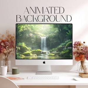 May include: A desktop computer displays an animated background of a waterfall in a lush green forest. The screen is set on a white desk with a keyboard, mouse, and decorative items, including dried flowers and a mug. The text "ANIMATED BACKGROUND" is at the top.