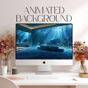 May include: An Apple iMac computer displays an animated underwater scene with sunlight streaming through the water. The screen is set on a white desk with a keyboard, mouse, and decorative flowers. The text "ANIMATED BACKGROUND" is displayed above the screen.