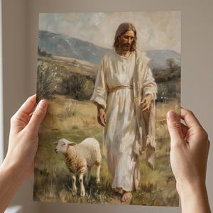 May include: An art print depicting a figure in white robes walking alongside a lamb in a grassy field. The background features rolling hills and a cloudy sky, with soft, muted colors dominating the scene.