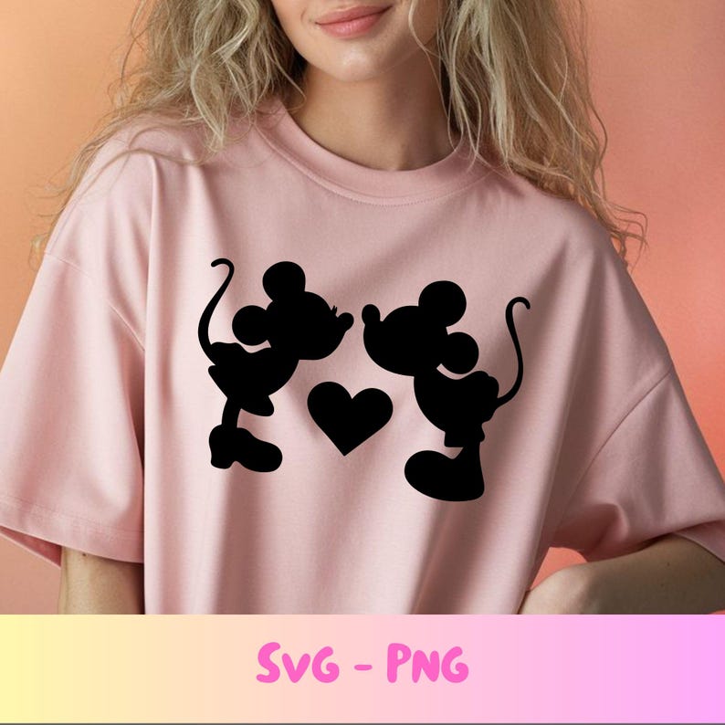 May include: A light pink t-shirt featuring a black silhouette design of two cartoon mice facing each other, with a heart between them. The text "SVG - PNG" is at the bottom of the shirt.