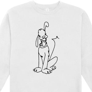 May include: White sweatshirt featuring a black line drawing of a cartoon dog with its tongue out. The dog is sitting with its tail curled. The sweatshirt has a crew neck and long sleeves.
