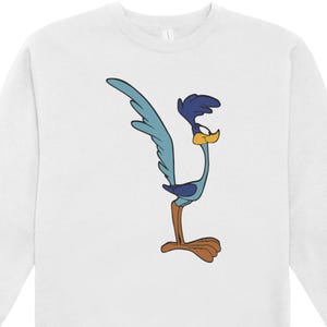May include: White sweatshirt with a cartoon Road Runner design. The Road Runner is shown in blue, brown, and yellow, in a running pose. The sweatshirt has a crew neck and is suitable for everyday wear.