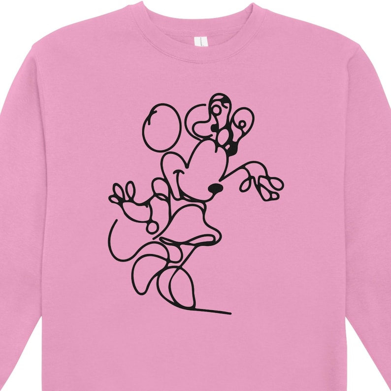 May include: Pink sweatshirt featuring a black line drawing of a cartoon character. The design depicts a character with large ears, a bow, and a skirt. The sweatshirt has a crew neck and long sleeves, suitable for casual wear.