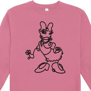 May include: Pink sweatshirt featuring a black line drawing of a cartoon duck character. The illustration depicts the duck in a dress and shoes, with a whimsical, minimalist style. The sweatshirt is a solid pink color.