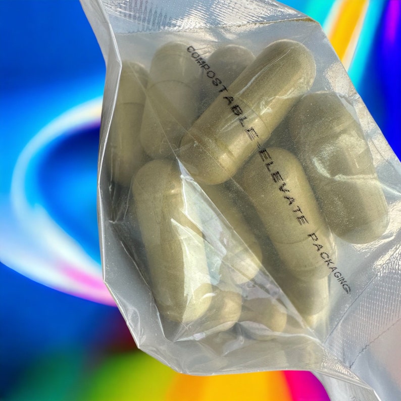 May include: A clear plastic bag filled with multiple green capsules. The bag has the text "COMPOSTABLE ELEVATE PACKAGING" printed on it.