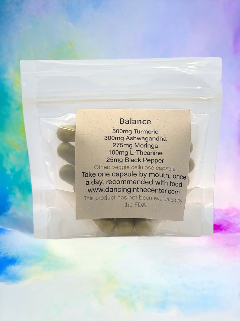 May include: A clear plastic bag filled with green capsules labeled "Balance" with the following ingredients: 500mg Turmeric, 300mg Ashwagandha, 275mg Moringa, 100mg L-Theanine, 25mg Black Pepper. The label also states "Other: veggie cellulose capsule" and "Take one capsule by mouth, once a day, recommended with food www.dancinginthecenter.com This product has not been evaluated by the FDA."