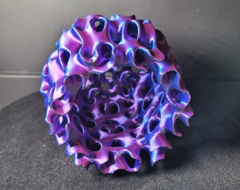 May include: A 3D printed, iridescent purple and blue, hollow sphere with a textured, organic, honeycomb-like design.