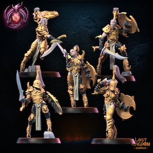 May include: Five miniature figures of female warriors wearing gold armor and holding swords and shields. The figures are posed in dynamic stances and have detailed features. The figures are set against a dark blue background.