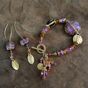 Lavender and pink beaded bracelet and earring set.  Specialty beads including one of a kind blown glass beads. Toggle clasp.
