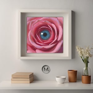 May include: A close-up of a pink rose with a blue eye in the center. The rose is in focus, and the eye is slightly blurred.