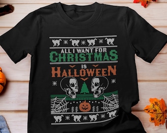 May include: Black t-shirt with a green and white Christmas sweater design. The text on the shirt reads "All I want for Christmas is Halloween".