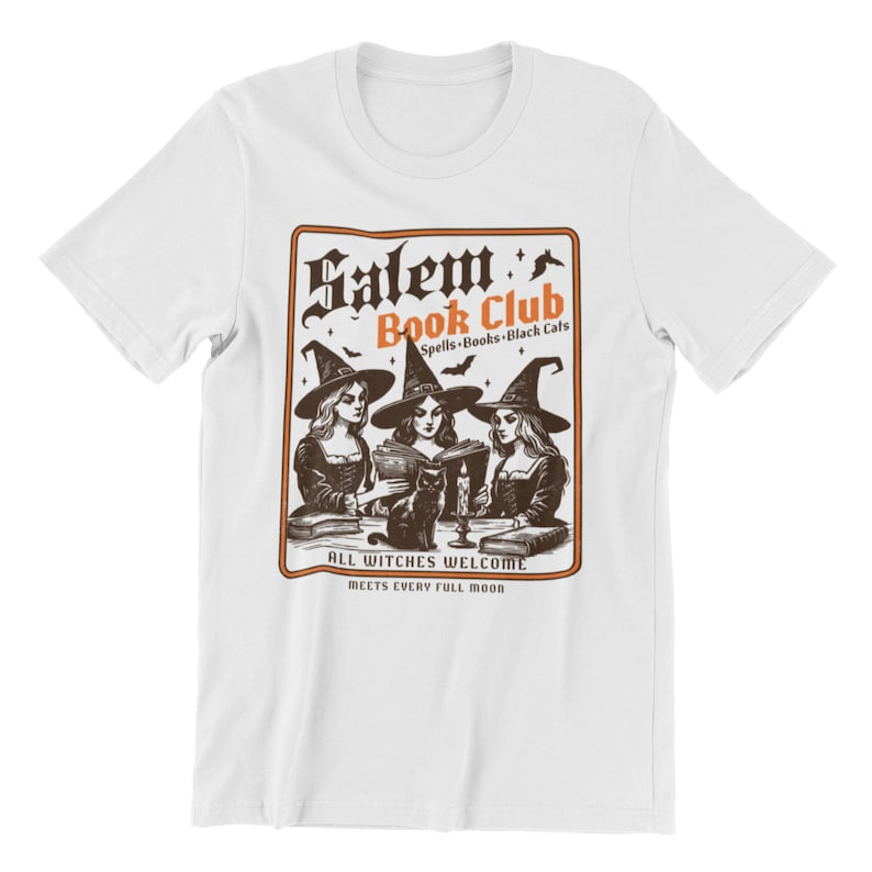 May include: White t-shirt with a vintage-style illustration of three witches reading books in a circle. The text reads "Salem Book Club Spells-Books-Black Cats All Witches Welcome Meets Every Full Moon".