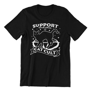 May include: Black t-shirt with a white graphic of a cat with the text "Support Your Local Cat Cult".