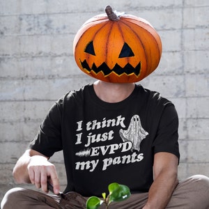 May include: A black t-shirt with a white ghost graphic and the text "I think I just EVP'D my pants".