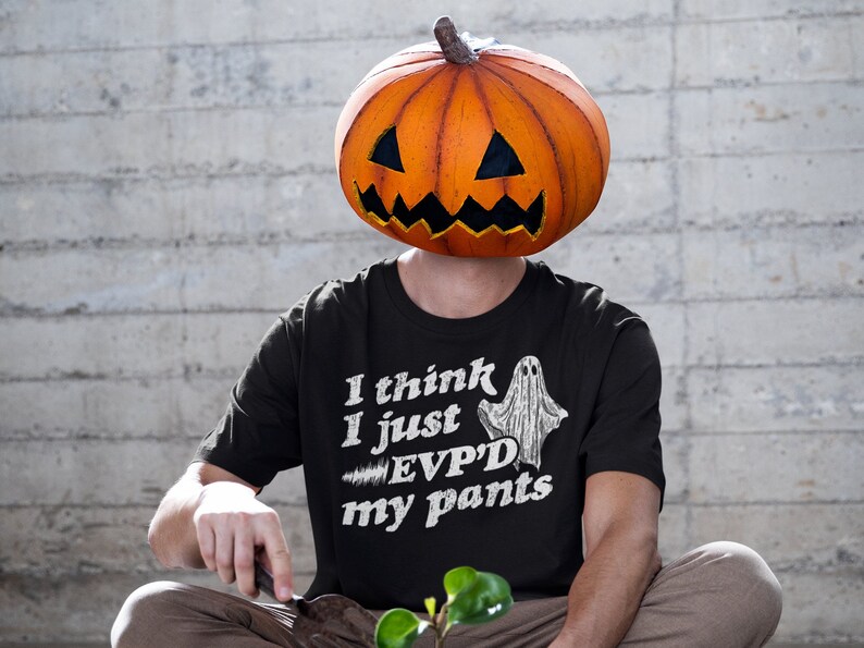 May include: A black t-shirt with a white ghost graphic and the text "I think I just EVP'D my pants".