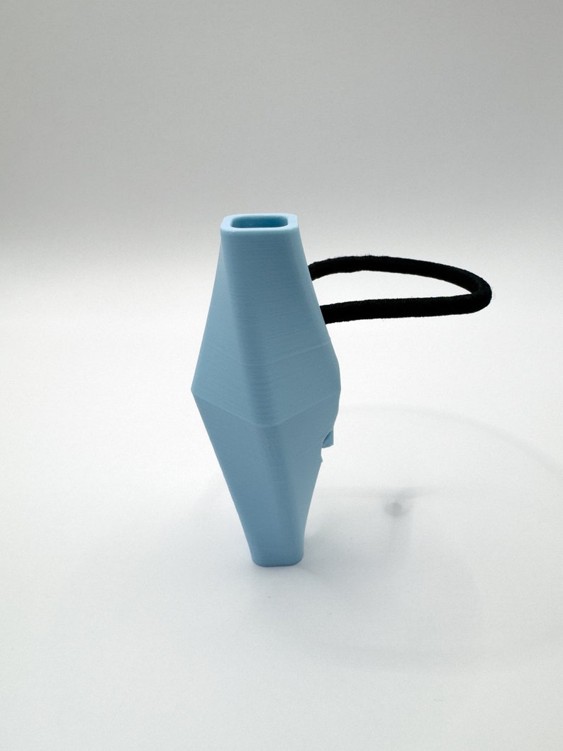May include: A light blue geometric-shaped hair tie with a black elastic band.