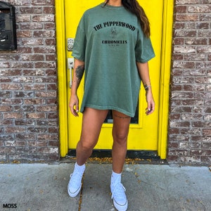 a woman standing in front of a yellow door