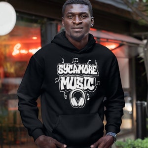 May include: A black hoodie with a white graphic design that says "Sycamore Music" with musical notes and headphones.