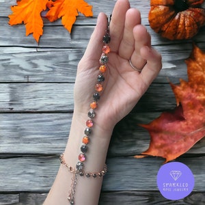 Witches Brew 8mm Crystal Bracelet with Opals. Genuine Austrian Crystal Bracelet. Women’s jewelry. Opal Jewelry. Orange/Black. Halloween.