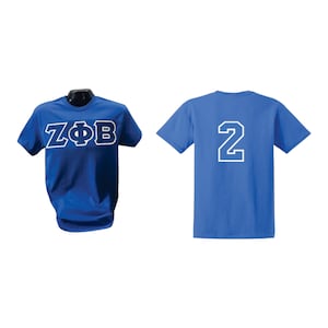 May include: Royal blue t-shirts. One shirt displays "ZΦB" in white block letters. The other shirt shows the number "2" in white. Both shirts are short-sleeved and made of a soft material.