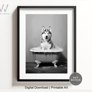May include: A black and white photo of a husky dog sitting in a bathtub full of bubbles. The dog is smiling and looking at the camera.
