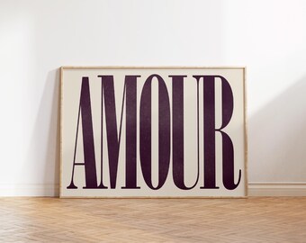 May include: A framed print with the word "AMOUR" in bold, dark purple letters on a white background.