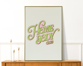 May include: A green and pink graphic print on a beige background with the text "Home Body Club".