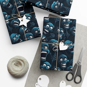 May include: Blue and black wrapping paper with a repeating pattern of cartoon skulls with white eyes and teeth. The paper is wrapped around a gift box with twine and a white heart-shaped tag.