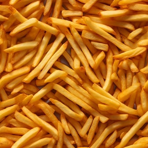 May include: A close-up image of a pile of golden brown chips.