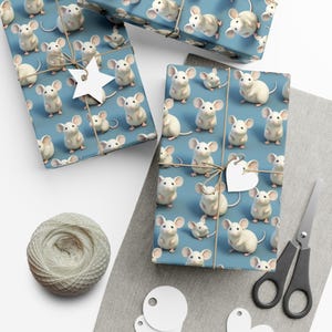 May include: Blue wrapping paper with a repeating pattern of white mice. The paper is wrapped around a gift box and tied with twine. There are white gift tags and a white star on the box.