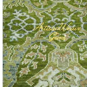 May include: A green and cream patterned rug with a traditional design. The rug has a subtle sheen and a soft texture.