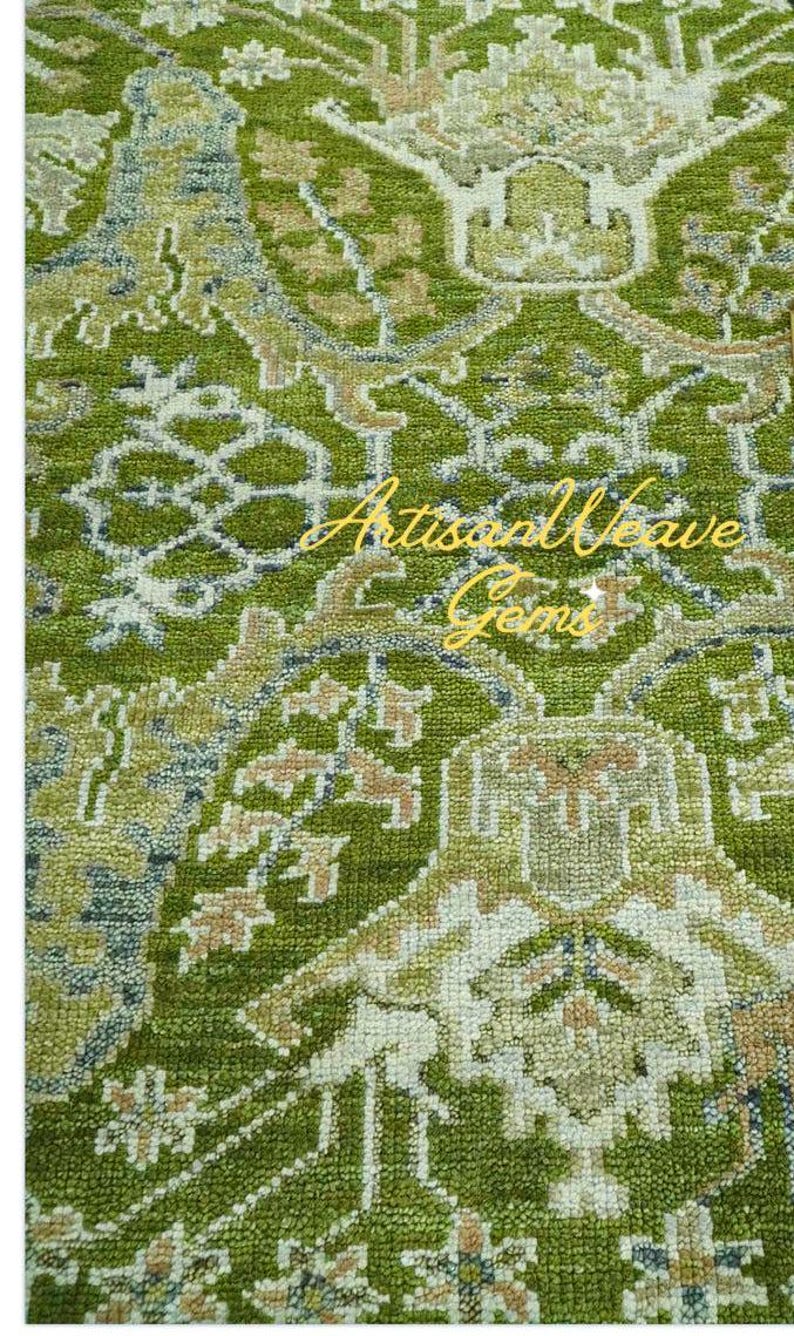 May include: A green and cream patterned rug with a traditional design. The rug has a subtle sheen and a soft texture.