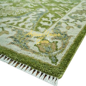 May include: A green and white patterned rug with a fringed border. The rug features a traditional design with intricate details.