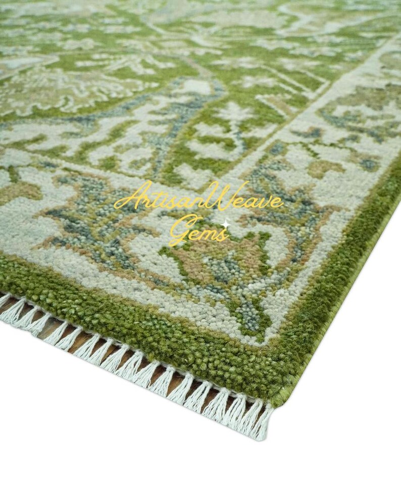 May include: A green and white patterned rug with a fringed border. The rug features a traditional design with intricate details.