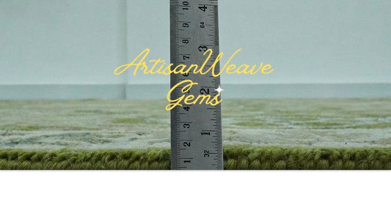 May include: Close-up of a green rug with a ruler measuring 10 cm. The text "Artisan Weave Gems" is visible in the image.