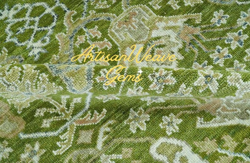 May include: A green rug with a floral pattern. The rug has a light brown and white design. The rug is made of wool and has a soft texture.
