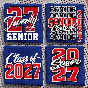 May include: Four blue t-shirts featuring various graphic designs in red, white, and black. The prints include the text '27', 'Twenty', 'SENIOR', 'Class of 2027', and 'SENIOR 2027' in bold athletic fonts and cursive script styles for graduation.