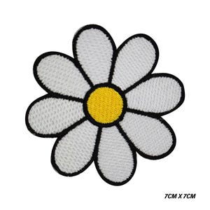 May include: Embroidered daisy patch with white petals, a yellow centre, and black outlines. The patch measures 7cm x 7cm.