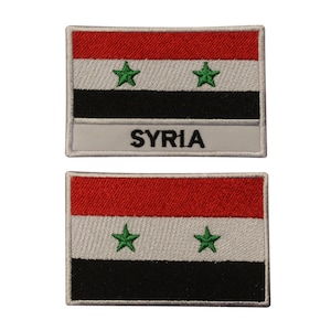 May include: Two embroidered patches featuring the flag of Syria. The top patch has the word "SYRIA" written below the flag. Both patches have a white border.