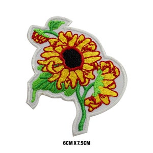May include: Embroidered iron-on patch featuring a yellow sunflower with a red centre and green leaves. The patch measures 6 cm by 7.5 cm.
