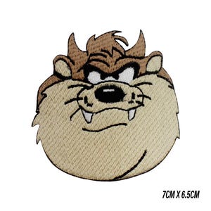 May include: Embroidered patch featuring the Tasmanian Devil cartoon character. The patch has a tan background with brown and black details. The patch measures 7cm x 6.5cm, or approximately 2.75 inches by 2.56 inches.