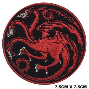 May include: A circular embroidered patch featuring a three-headed red dragon design on a black background with a red border. The patch measures 7.5 cm by 7.5 cm, which is approximately 2.95 inches by 2.95 inches, and includes white thread accents.