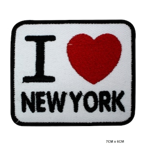 May include: Embroidered patch featuring the text "I ❤️ NEW YORK" in black with a red heart on a white base. The patch is rectangular with rounded corners and a black border. Dimensions are 7cm x 6cm.