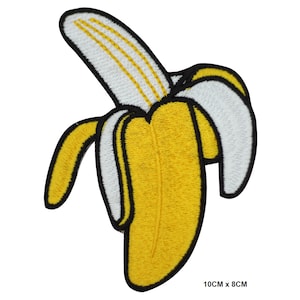 May include: An embroidered banana patch in yellow with a white peel and black outline. The patch measures 10 cm by 8 cm.