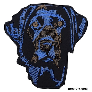 May include: Embroidered iron-on patch of a black Labrador Retriever dog's head with blue and brown details. The patch is 8 cm by 7.5 cm.