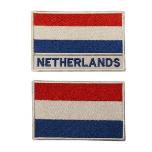 May include: Two embroidered patches featuring the Dutch flag. The top patch has the word "NETHERLANDS" written below the flag. The bottom patch is just the flag.