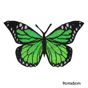 May include: Embroidered butterfly patch with green wings and black edges. The butterfly has white dots on the wing edges. The patch measures 9cm x 5cm.